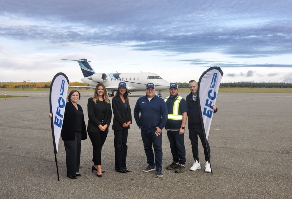 Executive Flight Centre and Prince George Airport Authority staff standing in front of aircraft on apron.